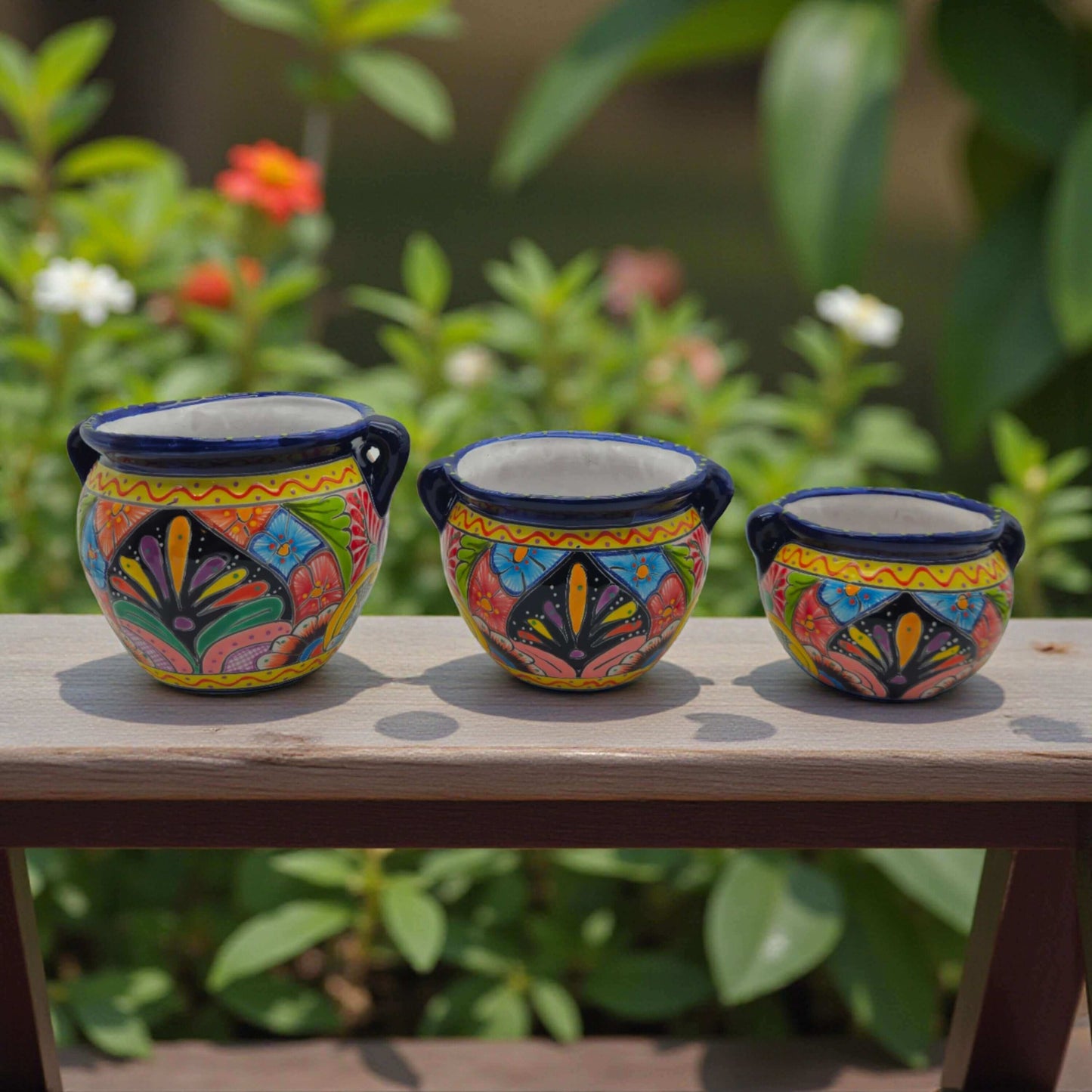 Cobalt Blue Rim Talavera Pot Trio | Small Hand-Painted Planters - three hand-painted cobalt-rimmed floral ceramic planters on a wooden ledge