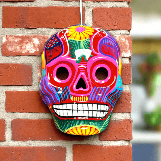 Colorful Calavera Skull | Hand-Painted Mexican Wall Art Decor — vibrant hand-painted Talavera skull with floral motifs on brick wall
