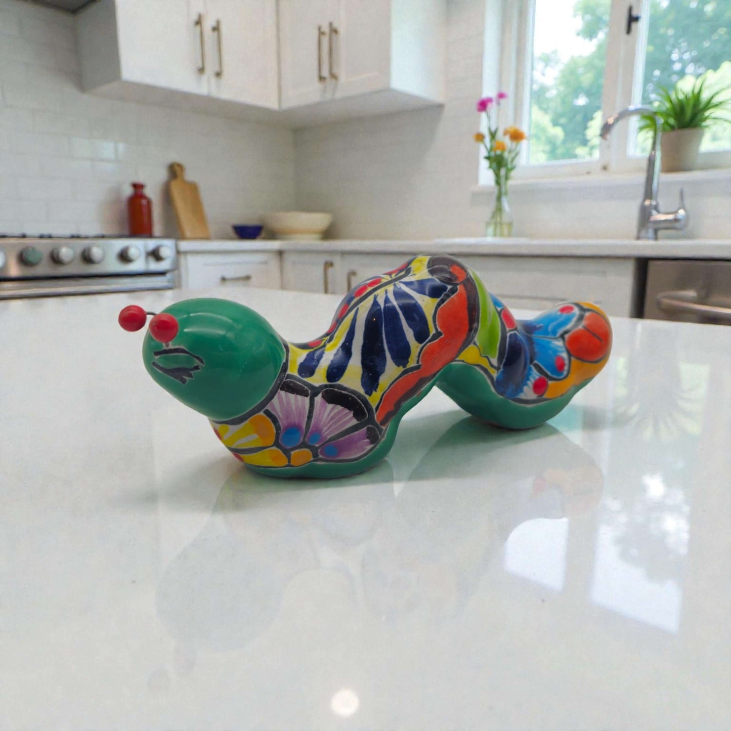 Colorful Talavera Caterpillar | Mexican Ceramic Figurine hand-painted glossy folk-art caterpillar on kitchen countertop