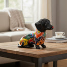 The Talavera Hub colorful ceramic dachshund figurine with floral patterns in orange, blue, red, and green.