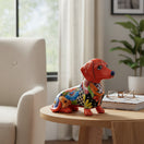 The Talavera Hub orange ceramic dachshund figurine with colorful floral patterns, handcrafted in Mexico.