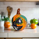 Talavera Jack-O'-Lantern | Colorful Mexican Pumpkin Decor hand-painted Talavera ceramic pumpkin with floral motifs on kitchen counter