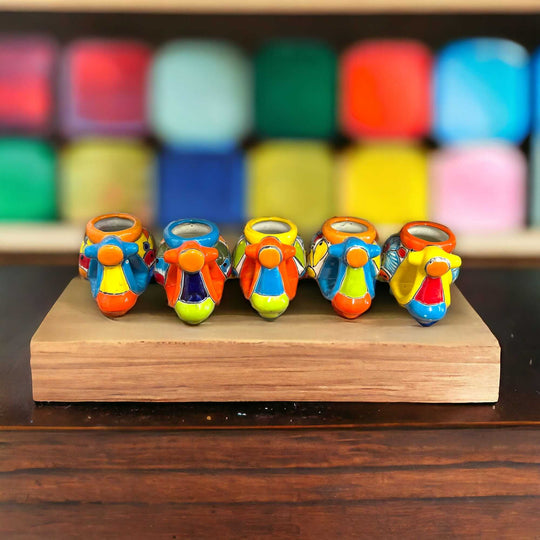 Colorful Talavera Scooter Planter | Mexican Art Decor - five hand-painted Talavera scooter planters on wooden display, vibrant Mexican ceramic decor