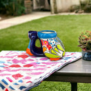 Colorful Talavera Scooter Planter | Mexican Art Decor - hand-painted Talavera scooter planter on outdoor table