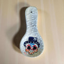 Colorful Talavera Skull Spoon Rest | Mexican Kitchen Art - hand-painted Talavera skull spoon rest with pink floral accents