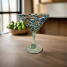 Confetti Pebbled Martini Glass | Hand-Blown Mexican Barware on wooden table, colorful hand-blown pebble pattern and classic martini silhouette