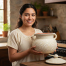 Cream Talavera Bean Pot with Lid | Handcrafted Mexican Clay - woman holding handcrafted cream Talavera bean pot with embossed floral motifs and matching lid
