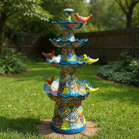 The Talavera Hub multicolor ceramic garden fountain with bird accents, hand-painted floral motifs, and a light blue rim.