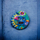 Guerrero Sun Moon Wall Art | Hand-Painted Mexican Eclipse Decor - hand-painted Talavera sun-moon with florals and tropical bird on black background