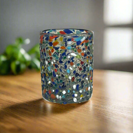 Confetti Pebbled Tumbler | Hand-Blown Mexican Glassware - hand-blown pebbled glass tumbler with blue, orange, green confetti on wooden table