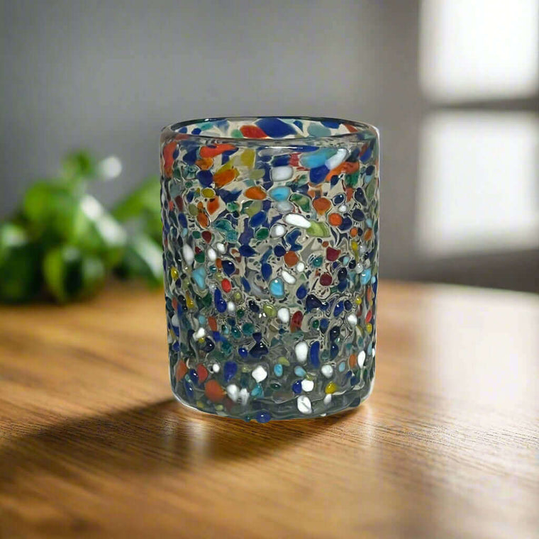 Confetti Pebbled Tumbler | Hand-Blown Mexican Glassware - hand-blown pebbled glass tumbler with blue, orange, green confetti on wooden table
