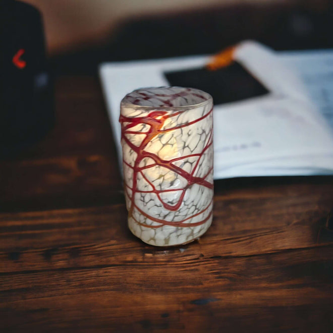 Mexican Hand Blown Drinking Glasses | Elegant White and Red hand-blown tumbler with white crackle finish and red swirl details on wooden table