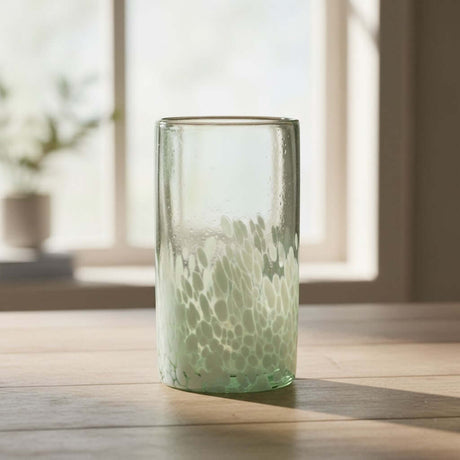 The Talavera Hub hand-blown Mexican highball glass with clear top and white pebble pattern base. Recycled glass.