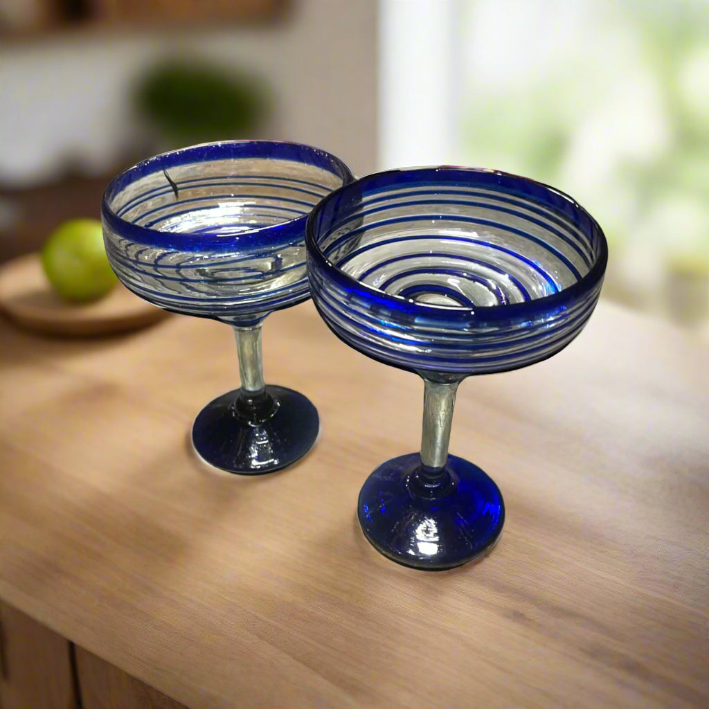 Mexican Margarita Glass | Hand-Blown Blue Swirl Cocktail Cup - pair of hand-blown cobalt blue swirl margarita glasses on wood table