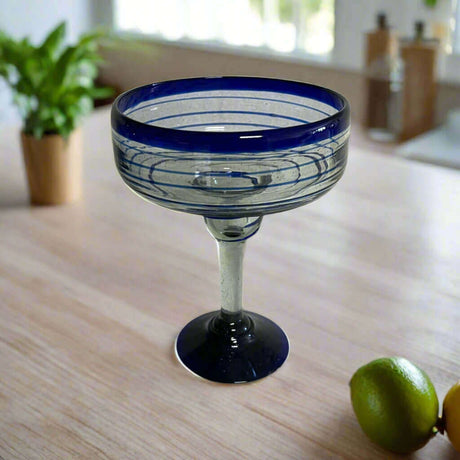 Mexican Margarita Glass | Hand-Blown Blue Swirl Cocktail Cup - hand-blown clear glass with cobalt blue rim and swirl accents on countertop