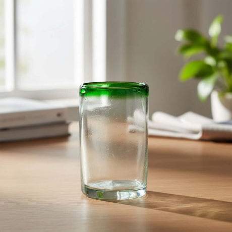 The Talavera Hub hand-blown clear glass tumbler with emerald green rim, 5" tall, artisan crafted in Mexico.