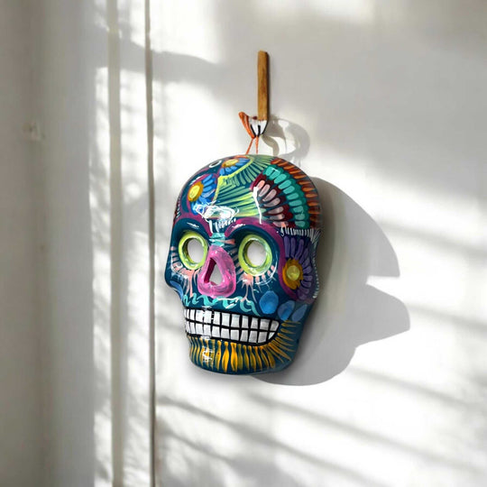 Colorful Calavera Skull | Hand-Painted Mexican Wall Art Decor hanging on white wall, hand-painted vibrant floral design, kiln-fired glazed