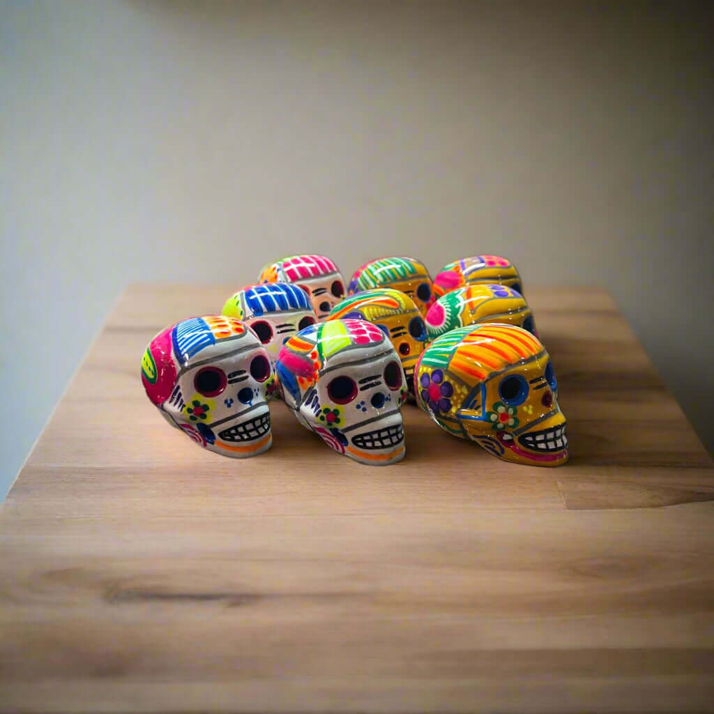 Hand-Painted Guerrero Skull | Colorful Mexican Artisan Statue - group of small hand-painted Guerrero pottery skulls with bright floral designs