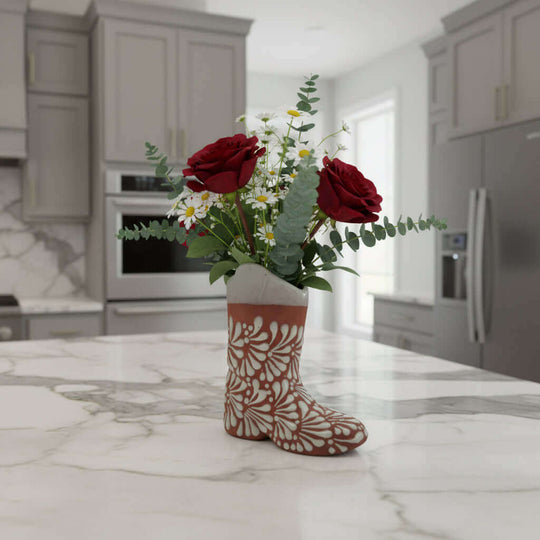 Talavera Boot Planter | Hand-Painted Mexican Pottery Accent displayed as a floral boot vase with red roses on a marble kitchen island