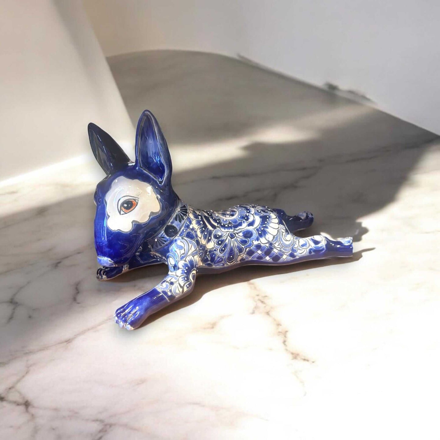 Talavera Bull Terrier Statue | Hand-Painted Colorful Dog Sculpture – blue and white hand-painted Talavera bull terrier figurine with red eye patch