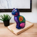 Talavera Cat Piggy Bank | Hand-Painted Mexican Ceramic Coin Holder - hand-painted purple floral ceramic cat on wooden stand