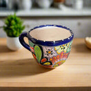 Talavera Coffee Mug | Hand-Painted Mexican Ceramic Cup showcasing colorful hand-painted flowers, cobalt blue rim, handcrafted in Guanajuato, Mexico