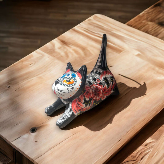 Hand-Painted Talavera Stretching Cat Statue | Day of the Dead Mexican Decor - hand-painted Talavera stretching cat figurine on wooden table