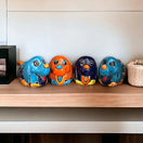 Vibrant Hand-Painted Talavera Dog Planter | Small Mexican Animal Pottery - four colorful hand-painted Talavera dog planters on shelf