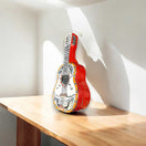 Talavera Guitar Statue | Hand-Painted Mexican Folk Art Decor - vibrant red hand-painted Talavera guitar sculpture with floral patterns on wooden table