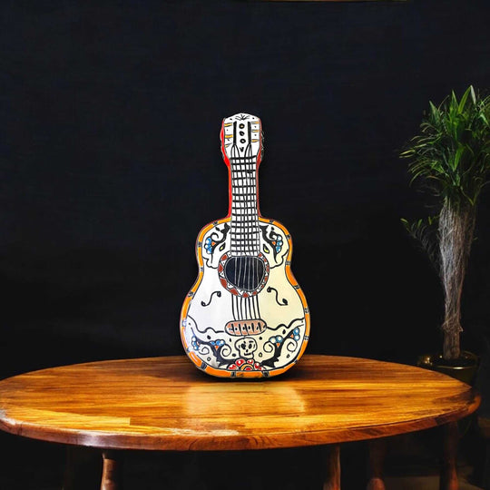 Talavera Guitar Statue | Hand-Painted Mexican Folk Art Decor on wooden table, vibrant hand-painted floral and geometric patterns