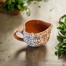 Talavera Heart Mug | Hand-Painted Mexican Coffee Cup — hand-painted terracotta heart-shaped mug with white floral Talavera pattern
