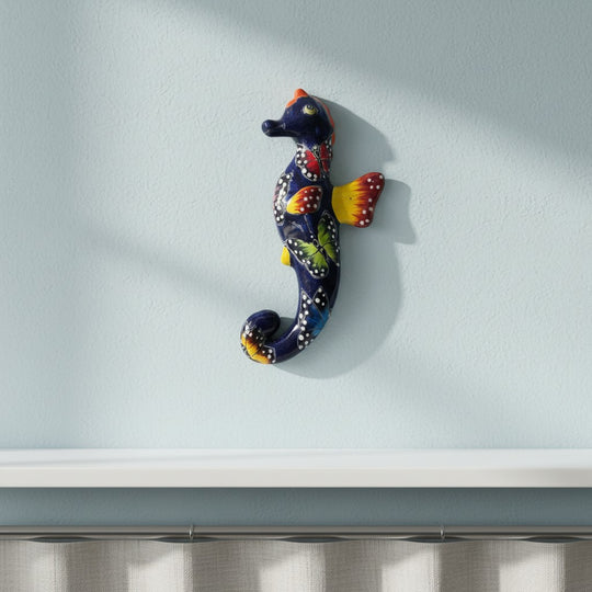 The Talavera Hub hand-painted ceramic seahorse figurine with butterflies in orange, blue, and pink. 8" tall.
