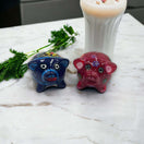 Set of 2 Pig Salt and Pepper Shakers | Hand-Painted Mexican Pottery - hand-painted blue and red pig shakers on marble with parsley and milk glass