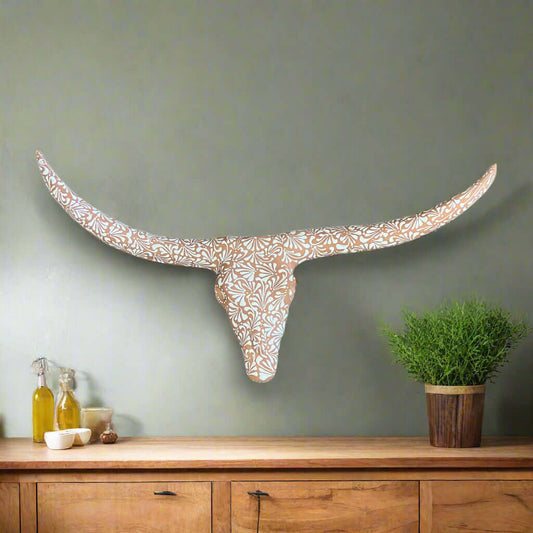 Terracotta Longhorn Wall Art | Hand-Painted Mexican Bull Skull displayed on gray wall with floral terracotta pattern over console