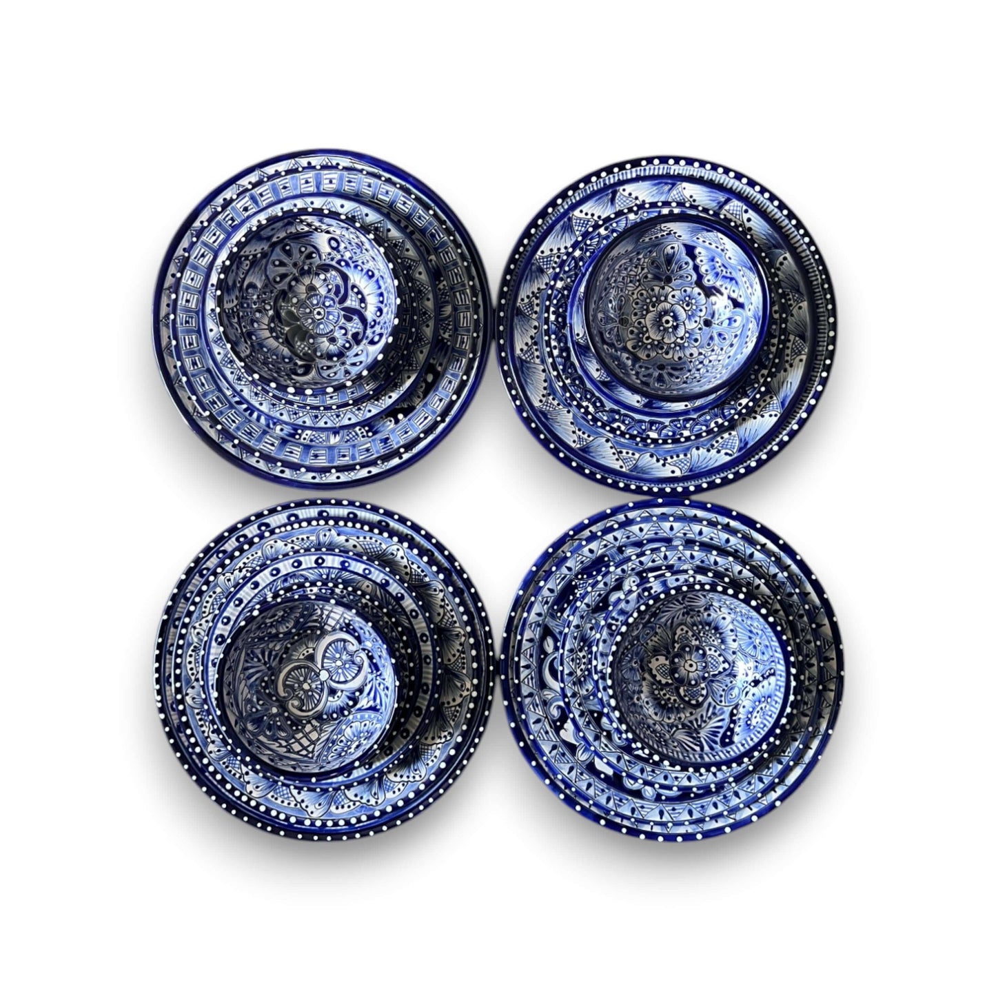 30-Piece Talavera Dinnerware Set | Blue & White Tableware for 6 - overhead view of four hand-painted blue and white Talavera plates and bowls