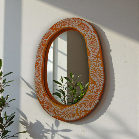 Floral Brown & White Talavera Mirror | Handcrafted Mexican Art handcrafted oval Talavera mirror with brown frame and white floral motifs hung on wall