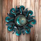 Vibrant Sun Wall Art | Handcrafted Mexican Metal Decor (24-inch Diameter) teal hand-painted metal sun with kiln-fired lead-free glaze on wood background