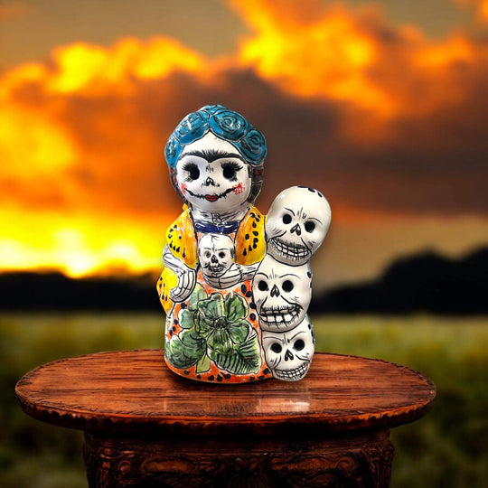 Handcrafted Talavera Frida Statue | Colorful Day of the Dead Calavera Skull Decor on wooden table with sunset background, hand-painted Mexican Talavera