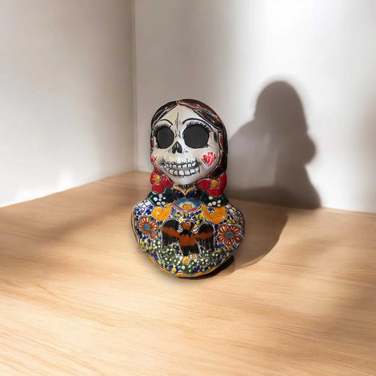 Vibrant Talavera Skeleton Woman Statue | Handcrafted Day of the Dead Decor - hand-painted Talavera skeleton woman on wood surface