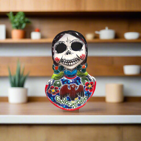 Vibrant Talavera Skeleton Woman Statue | Handcrafted Day of the Dead Decor - hand-painted Talavera skeleton woman on shelf, colorful floral details