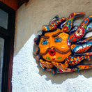 Handcrafted Talavera Sun Face | Colorful Mexican Wall Art — vibrant hand-painted Talavera sun face with mustache blowing a kiss, kiln-fired lead-free glaze