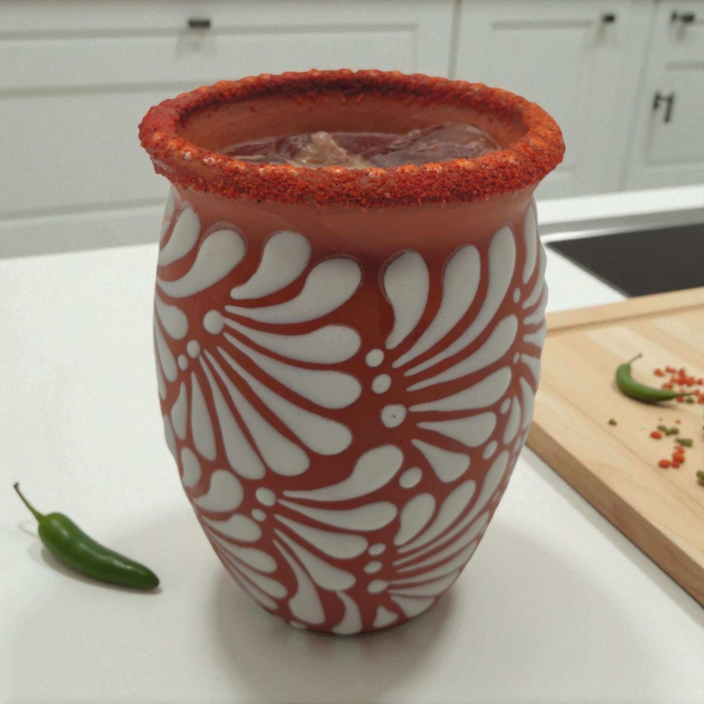 Terracotta Relief Cantarito | Handcrafted Mexican Pottery Cup with white floral relief and chili-rimmed drink, handcrafted in Guanajuato