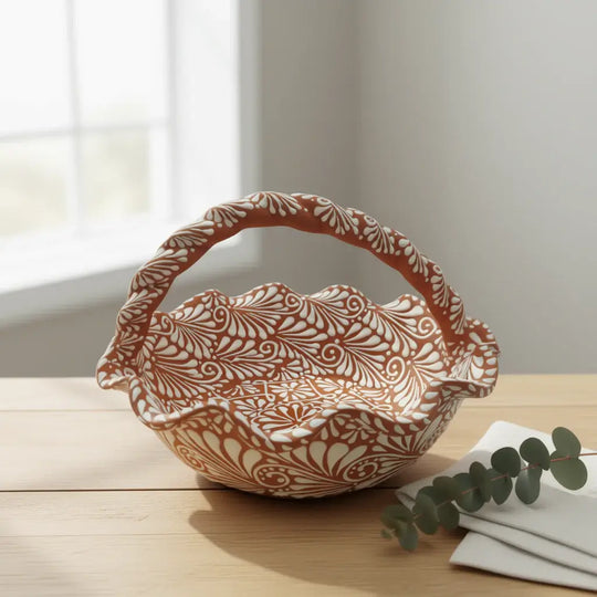Terracotta & White Talavera Basket | Handcrafted Ceramic Bowl on wooden table, handcrafted terracotta bowl with white floral patterns and twisted handle