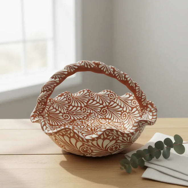Terracotta & White Talavera Basket | Handcrafted Ceramic Bowl on wooden table, handcrafted terracotta bowl with white floral patterns and twisted handle
