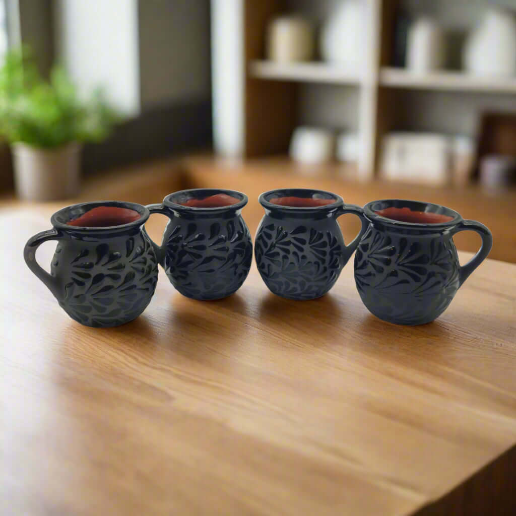 Black Talavera Jarrito Mug | Handmade Mexican Clay Coffee Cup - set of four hand-carved black glazed jarrito mugs with floral pattern, red interior