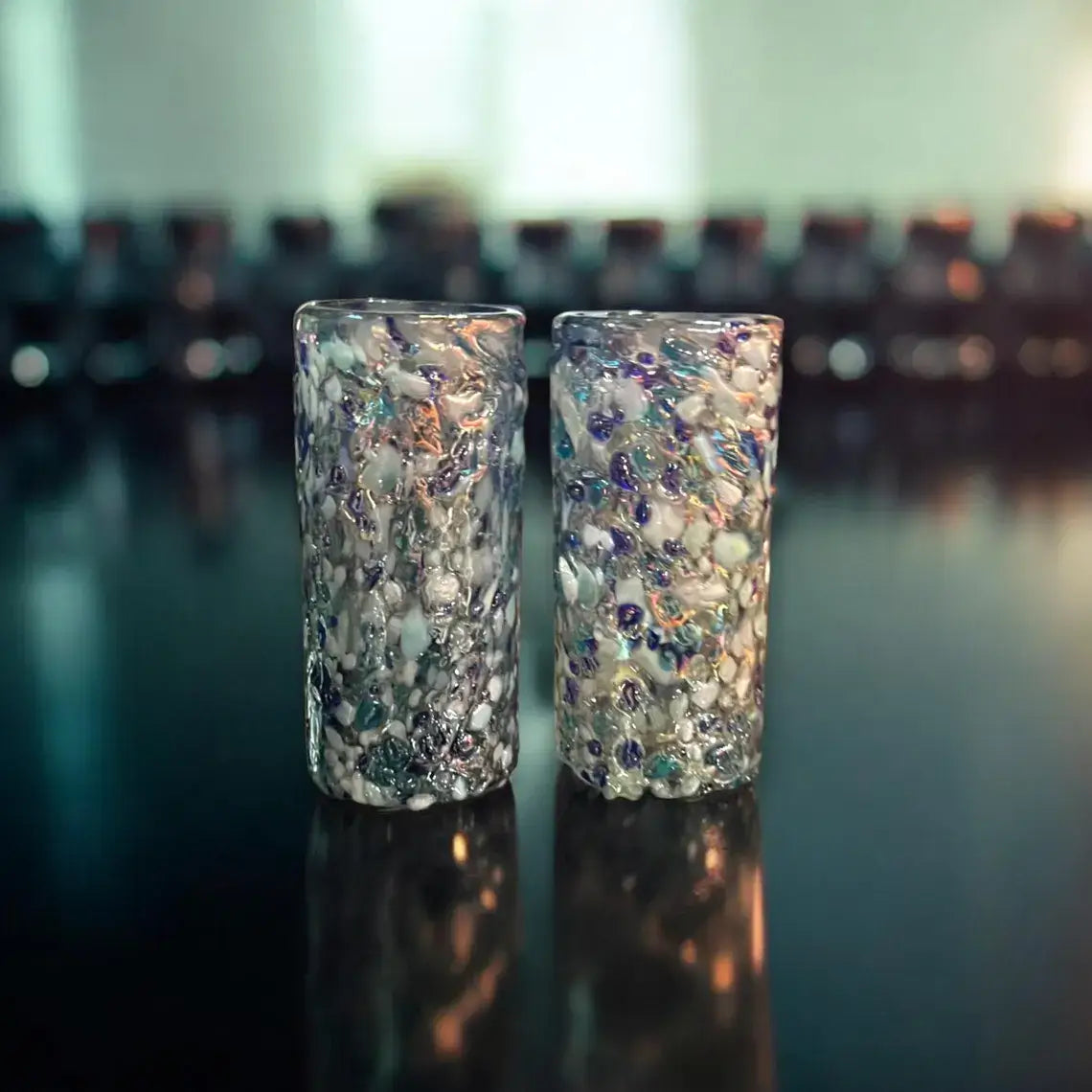 Handmade Blue and White Confetti Shot Glass | Artisanal Double Shot Glass - pair of hand-blown lead-free confetti double shot glasses on black surface