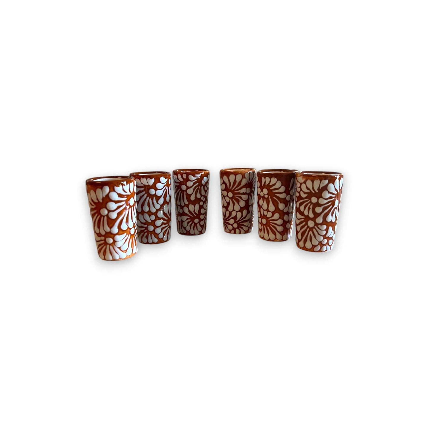 Handmade Skull Decanter Set | Brown & White Mexican Barware — six brown & white hand-blown skull shot glasses with floral motifs