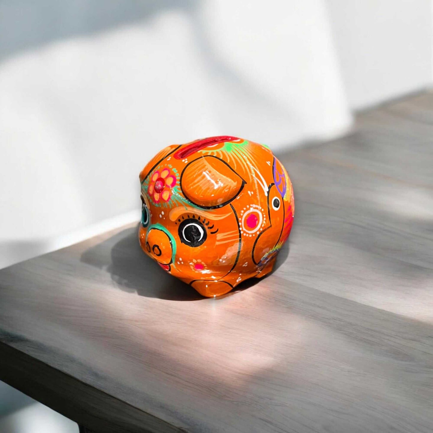 Handmade Guerrero Piggy Bank | Mexican Painted Ceramic Coin Bank (Small) - bright orange hand-painted Guerrero piggy bank on wooden table