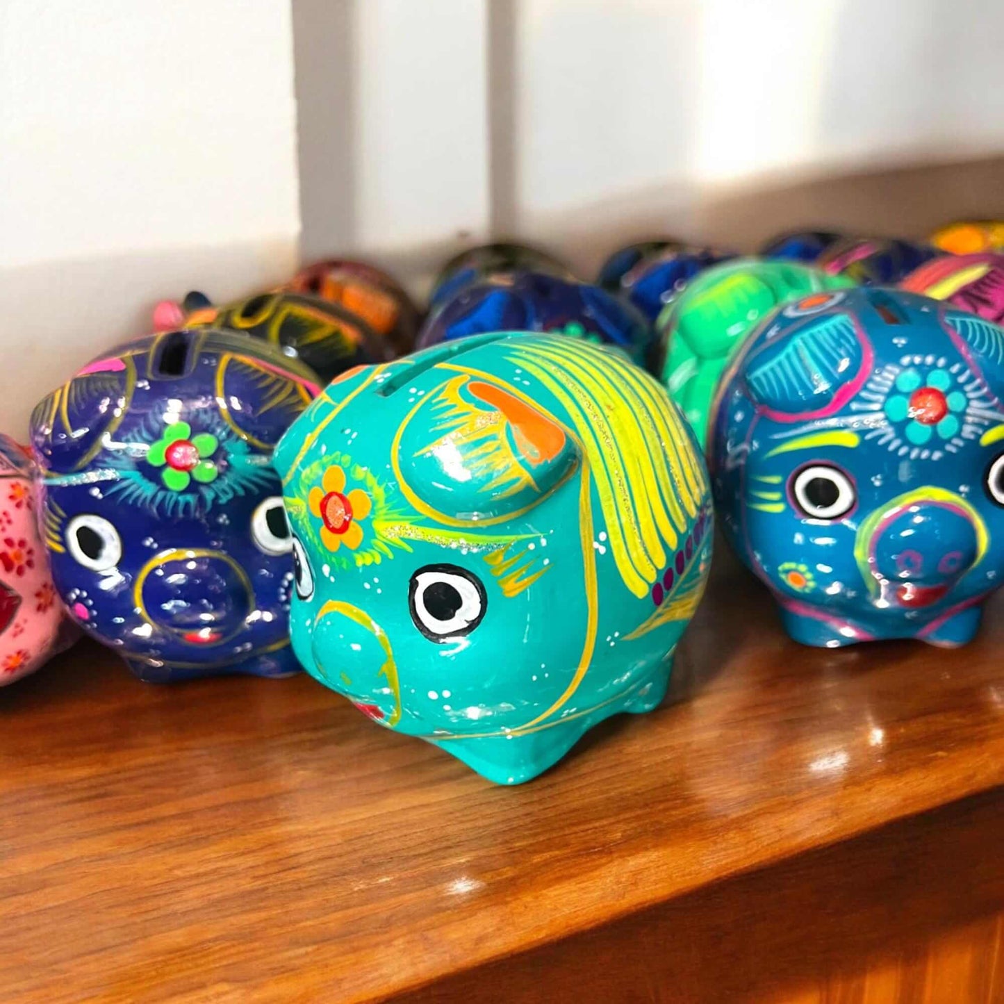Handmade Guerrero Piggy Bank | Mexican Painted Ceramic Coin Bank (Small) — hand-painted teal Guerrero pottery pig on wooden shelf