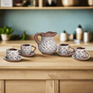 Heart Mug & Pitcher Set | Handmade Mexican Pottery (9-Pieces) - hand-painted white-patterned heart mugs with matching saucers and central pitcher